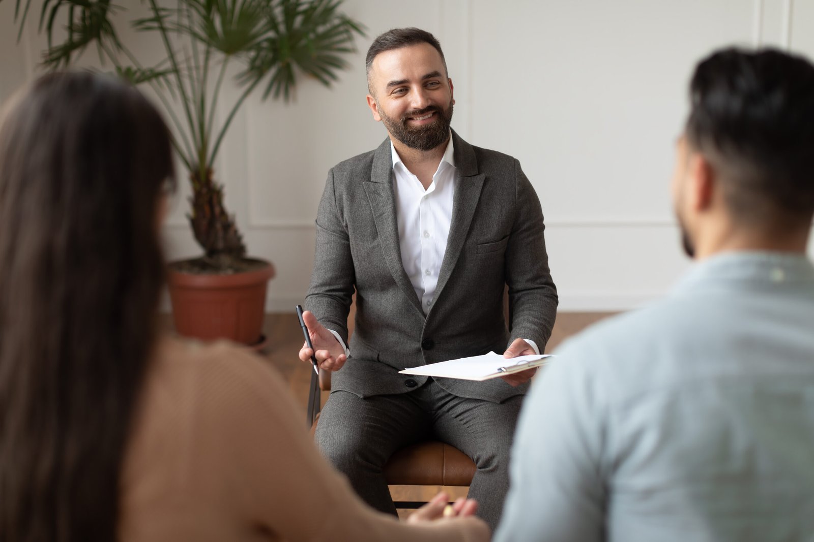 Young couple sitting at therapy session with therapist